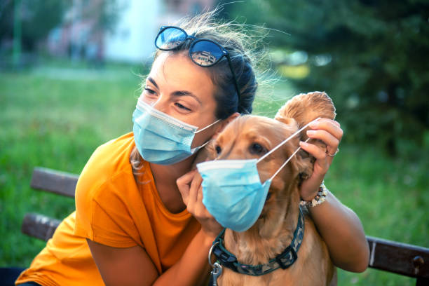 istock Woman and her dog with protective face mask 1333913956