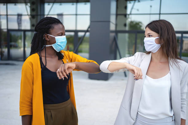 istock Happy women with protective face mask 1333913973