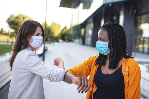 istock Happy women with protective face mask 1333914022