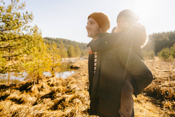 istock Father and son on a winter hike trail 1333916264