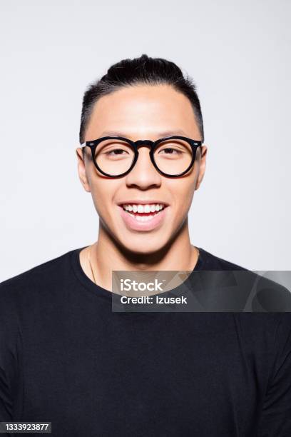 Cheerful Asian Young Man In Black Clothes Stock Photo - Download Image Now - Headshot, Asian and Indian Ethnicities, Men