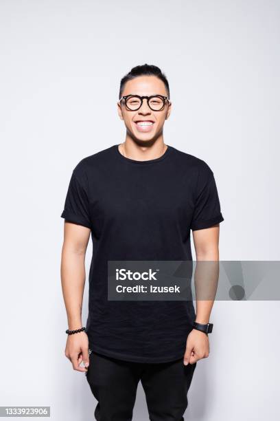 Cheerful Asian Young Man In Black Clothes Stock Photo - Download Image Now - T-Shirt, Black Color, Men