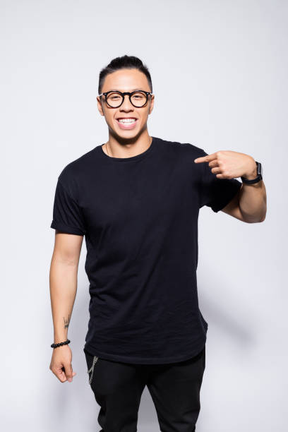 Cheerful asian young man in black clothes