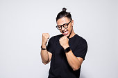 Excited asian young man in black clothes