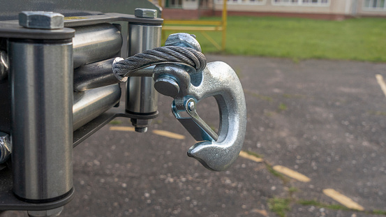 Off road car winch. Electric winch with hook in SUV bumper.