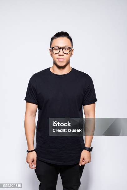 Friendly Asian Young Man In Black Clothes Stock Photo - Download Image Now - Men, Asian and Indian Ethnicities, Standing