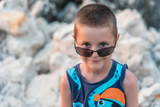 istock Happy kid standing on the cliff 1333924862