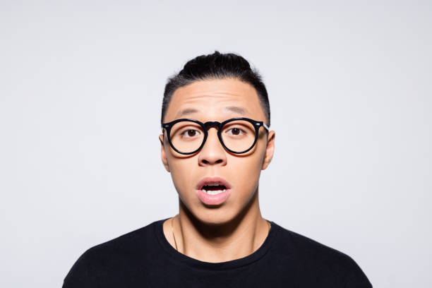 istock Shocked asian young man in black clothes 1333925030