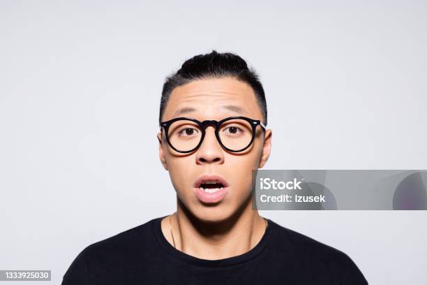 Shocked Asian Young Man In Black Clothes Stock Photo - Download Image Now - Shock, Terrified, Fear