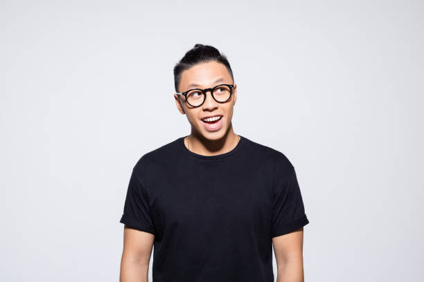 istock Surprised asian young man in black clothes 1333925098