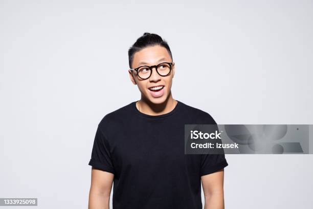 Surprised Asian Young Man In Black Clothes Stock Photo - Download Image Now - Portrait, Eyeglasses, Men