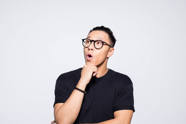 istock Surprised asian young man in black clothes 1333925142