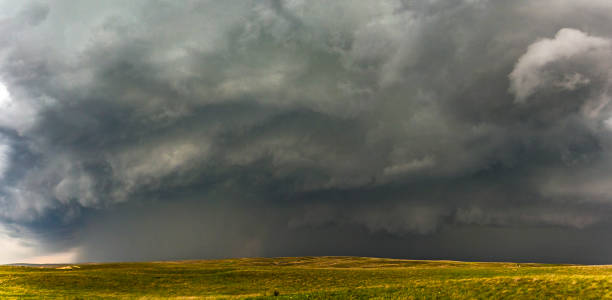 istock Panoramic view of severe thunderstorm, torrential rain over rolling grassland hills 1333925158