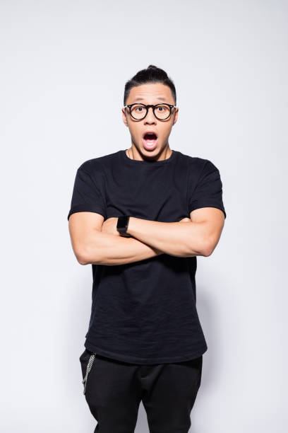 istock Surprised asian young man in black clothes 1333925205