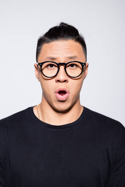 istock Surprised asian young man in black clothes 1333925773
