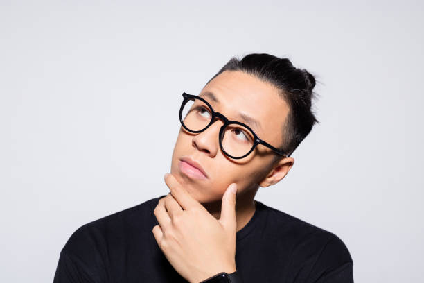 istock Thoughtful asian young man in black clothes 1333925835