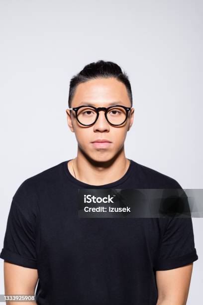 Worried Asian Young Man In Black Clothes Stock Photo - Download Image Now - Men, Eyeglasses, Portrait