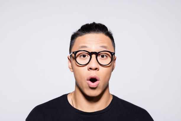istock Surprised asian young man in black clothes 1333925991