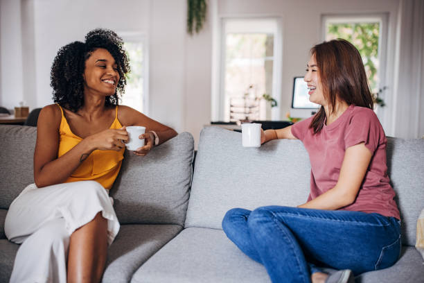 istock Two women gossiping at home 1333926449