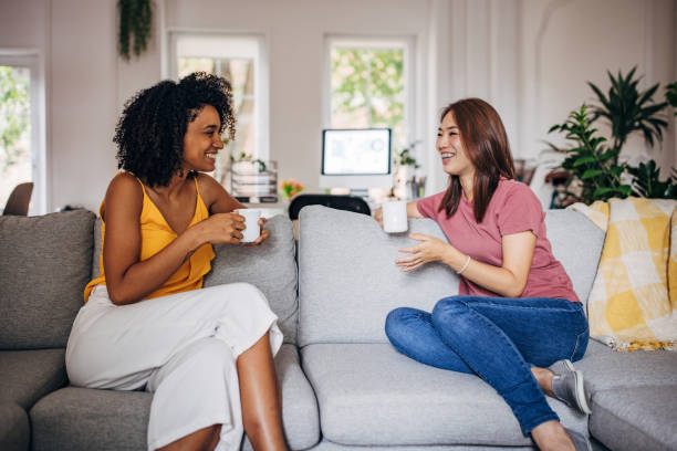 istock Two women gossiping at home 1333926973