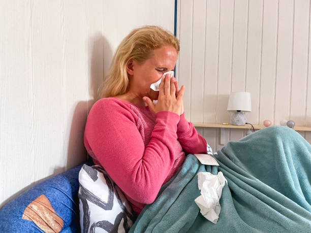 istock Caucasian Woman Blowing Her Nose In Bed 1333927079