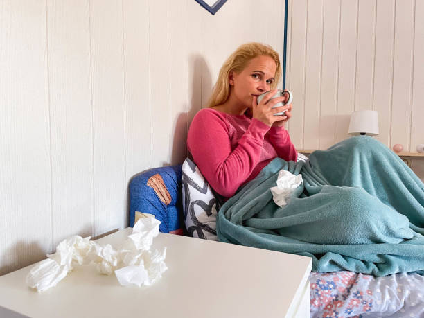 istock Caucasian Woman Drinking Tea In Bed And Looking At  Camera 1333927139