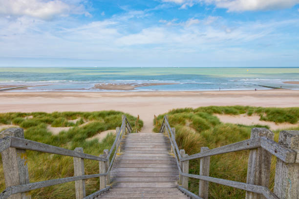 Stairs to the North Sea beach at Blankenberge, Belgium Wooden stairs through the dunes down to the North Sea beach at Blankenberge, Belgium coastal feature stock pictures, royalty-free photos & images