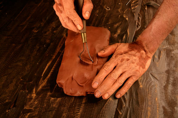 istock artist man hands working red clay for handcraft 1333932823