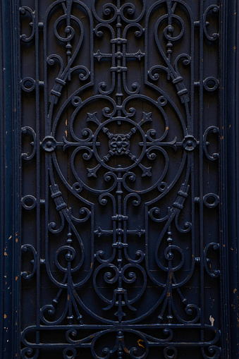 Close-up of iron work of front door. Seen in France.