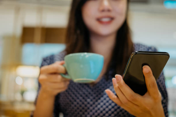 istock Young woman using smartphone during coffee break 1333934795