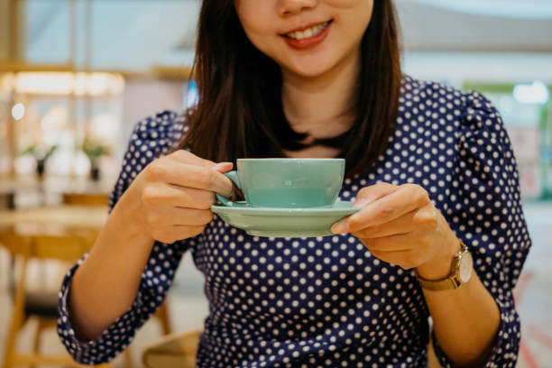 istock Young asian woman drinking coffee in cafe 1333934807