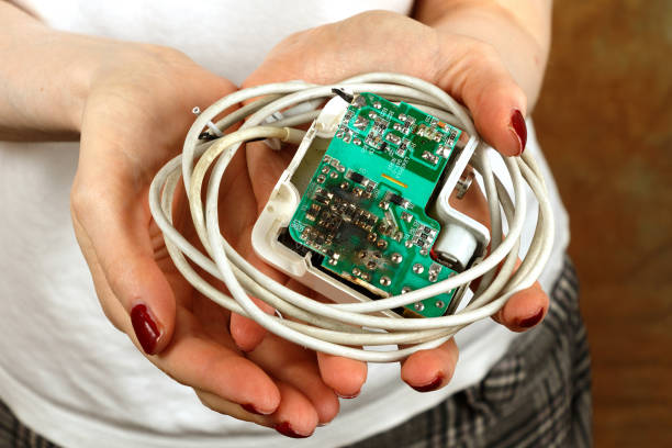 istock Female hands holding burnt charger 1333935831