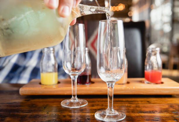 istock Pouring Champagne into a Glass During Brunch to Make a Mimosa 1333938252