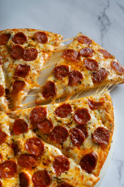 istock salami pizza on a white background. 1333938659