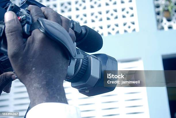 Man Filming With Video Camera Stock Photo - Download Image Now - Adult, Broadcasting, Communication Occupation