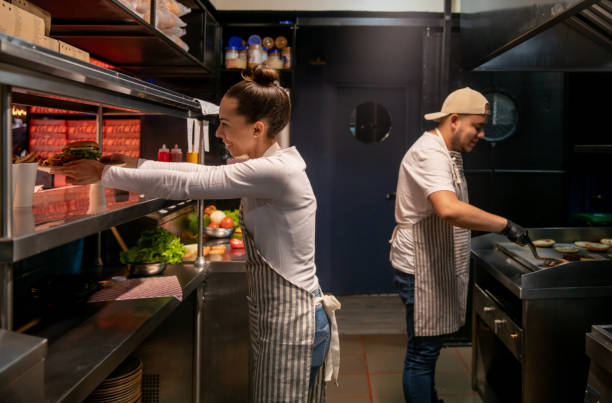 istock Cooks working at a fast food restaurant getting the orders ready 1333944288