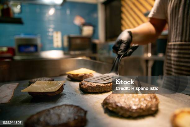 Closeup On A Chef Preparing Burgers At A Restaurant Stock Photo - Download Image Now