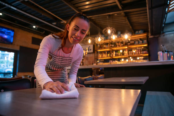 istock Waitress working at a restaurant cleaning the tables 1333944317