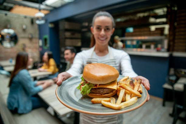 istock Waitress serving food at a fast food restaurant 1333944332