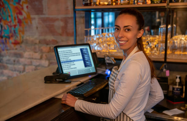 istock Waitress working at a restaurant and placing and order on the computer 1333944345