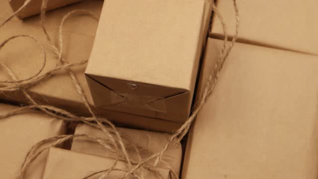 Boxes of different sizes, packed in brown paper, background