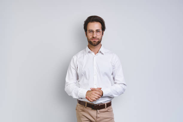 istock Handsome young man in white shirt looking at camera 1333946547