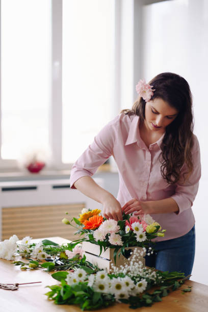 istock Beautiful florist arranging a flower composition 1333946787