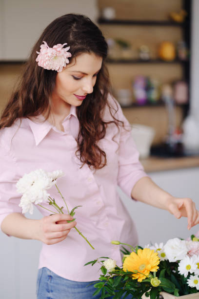 istock Beautiful florist arranging a flower composition 1333947331