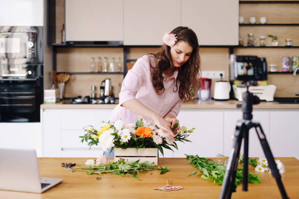 istock Woman using camera to stream home online tutorial on her blog 1333947353