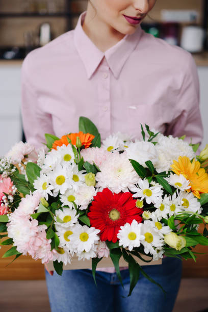 istock Woman holding a beautiful flower composition 1333948446