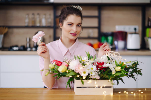 istock Beautiful florist arranging a flower composition 1333948551