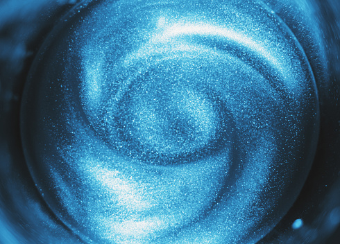 Simulation of a spiral galaxy using water and  spinning metallic particles.