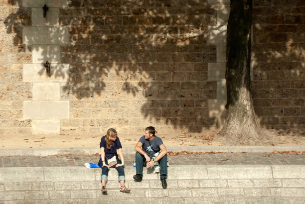 Rome, Italy: Aerial view of a loving couple walking alone on an empty cobbled Piazza della Minerva in downtown Rome.