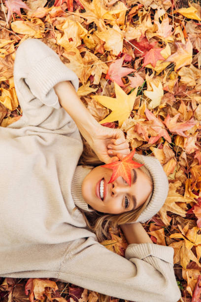 istock Beautiful woman lying on leaves 1333954452